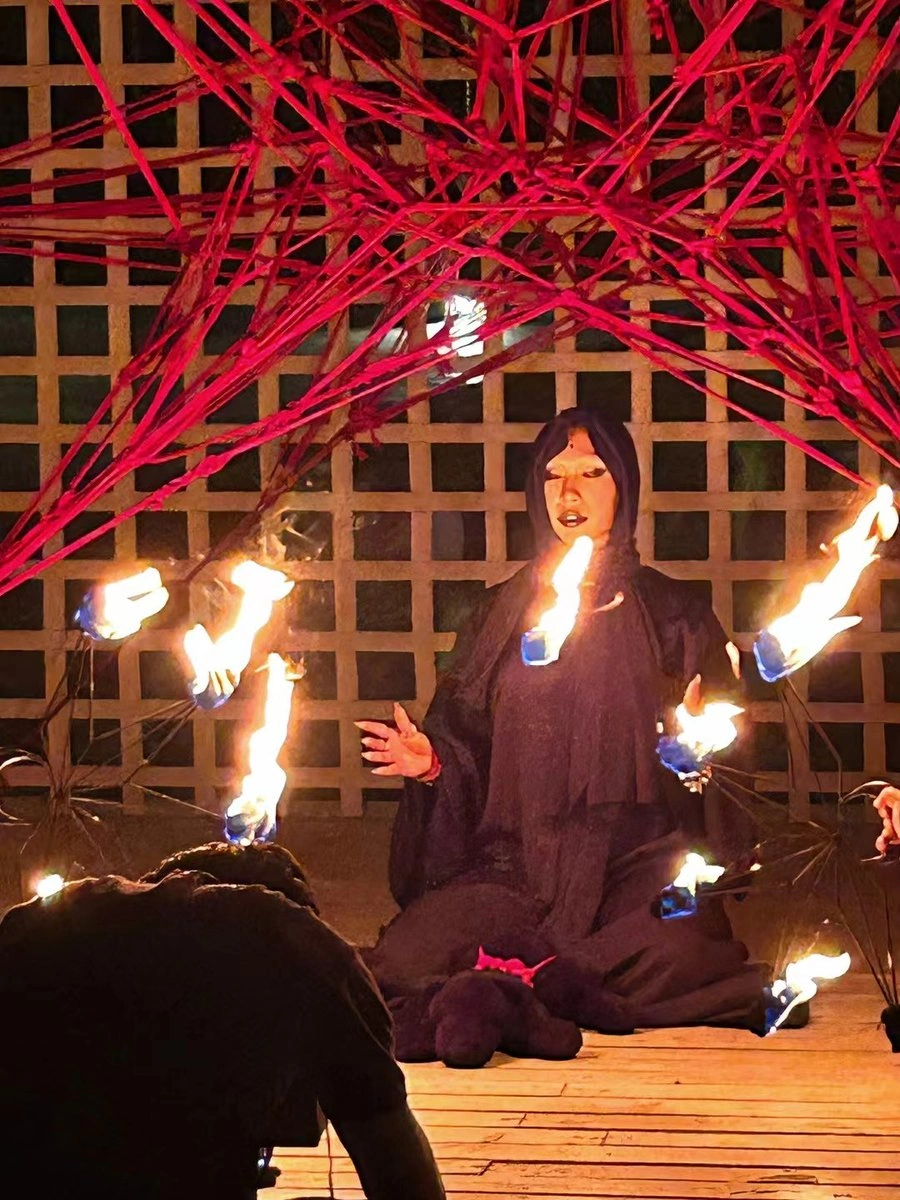 灰镜Chamber在夜间木台跪坐，穿深色斗篷并举起发光道具 写真