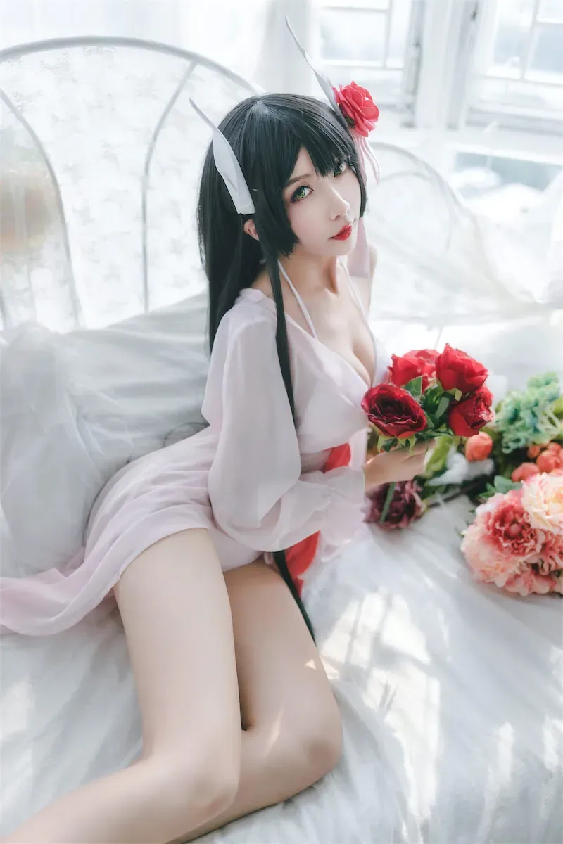 汤圆可甜了黑发白色服装手持红色花束坐在床上的写真